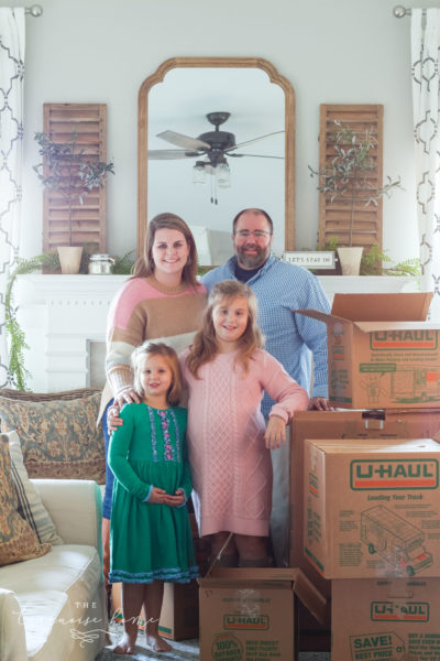 Family in front of fireplace with moving boxes