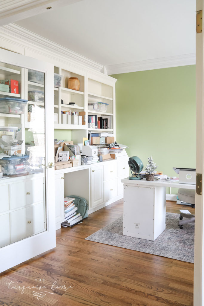 Lime green feminine office with built-in bookshelves. 