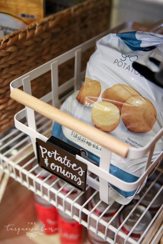 How to Organize a Pantry - white metal basket with wood handle for potatoes and onions