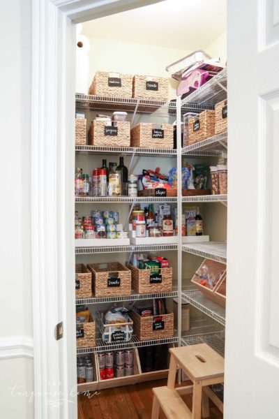 A decluttered and organized pantry with hyacinth baskets and wire shelving