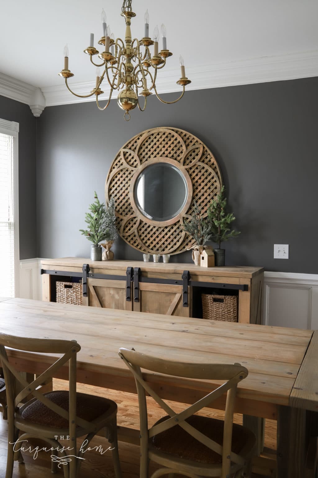 Kendall Charcoal dining room walls with wood buffet and large round mirror