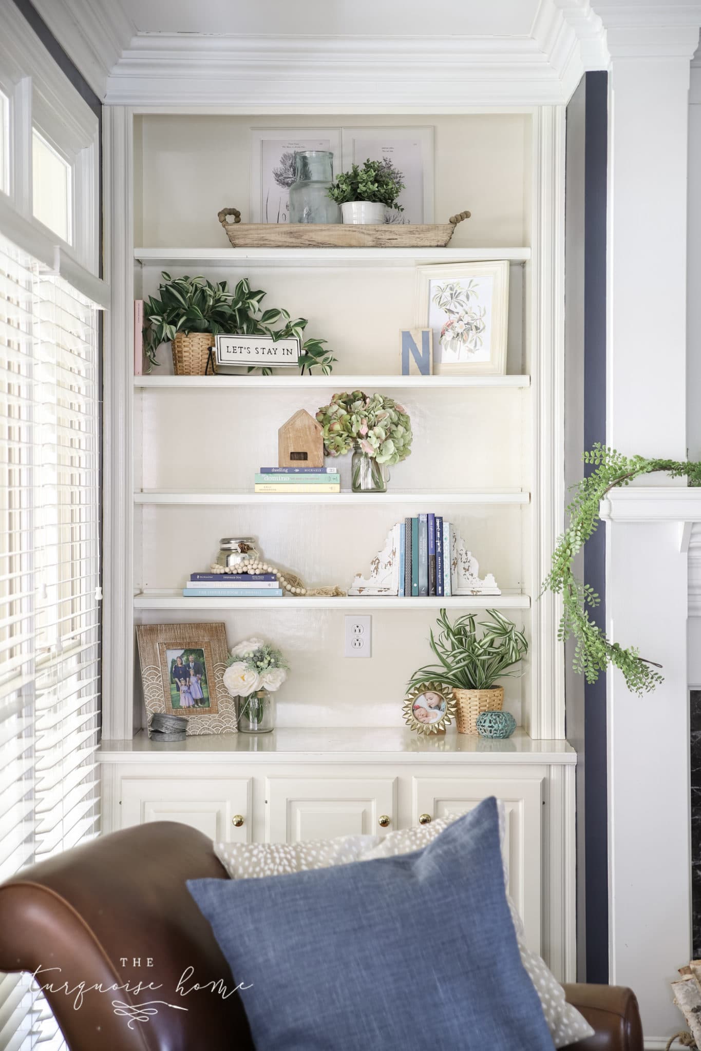 styling bookshelves with different ways of displaying books and trinkets together