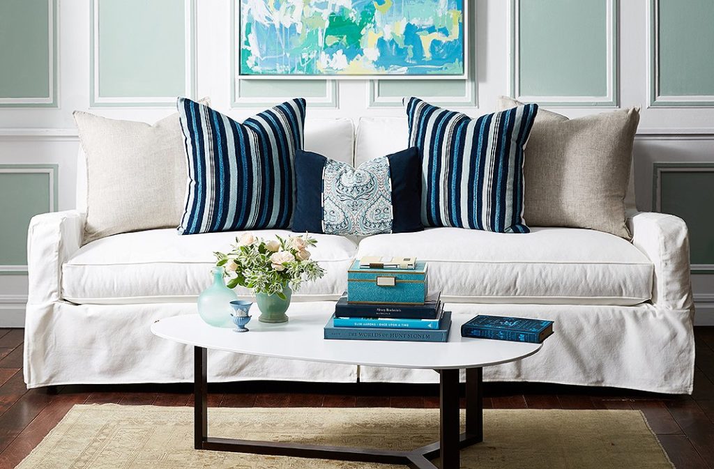 living room with cream sofa and dark blue throw pillows that bring in colors from all over the room