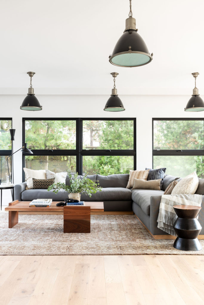 living room with a sectional couch with throw pillows in the corner