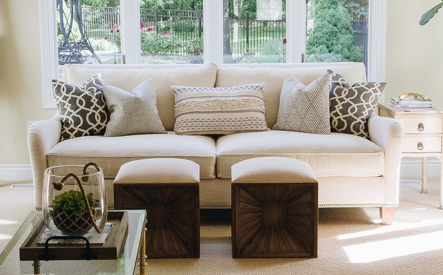 living room with couch sitting in front of windows and throw pillows on the couch