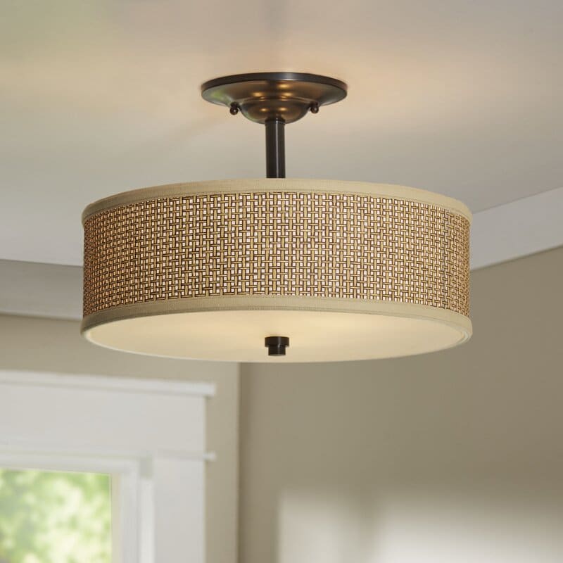 Drum pendant light with textured weave fabric.