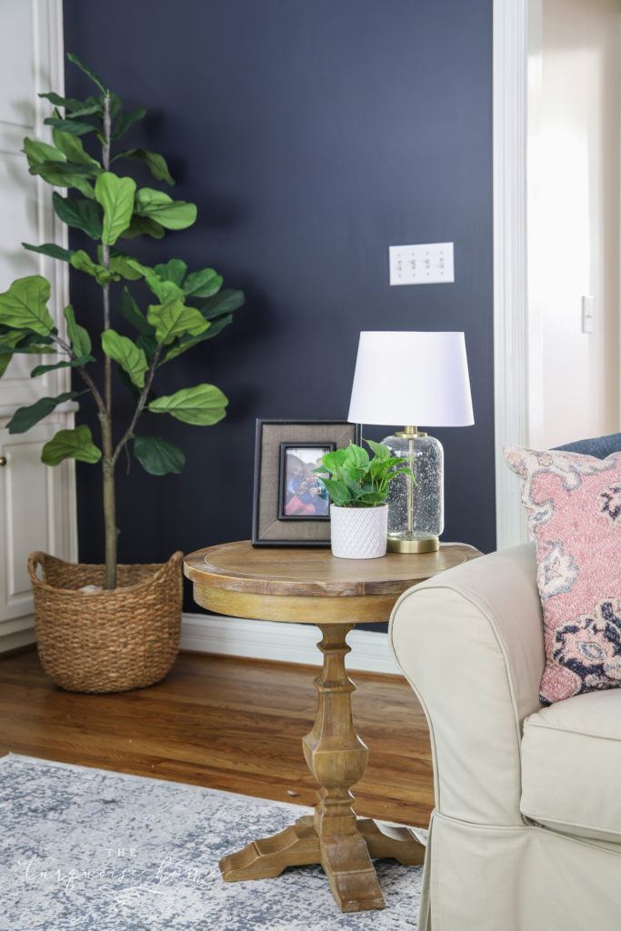 End Table Decor with a framed picture, potted plant and glass table lamp