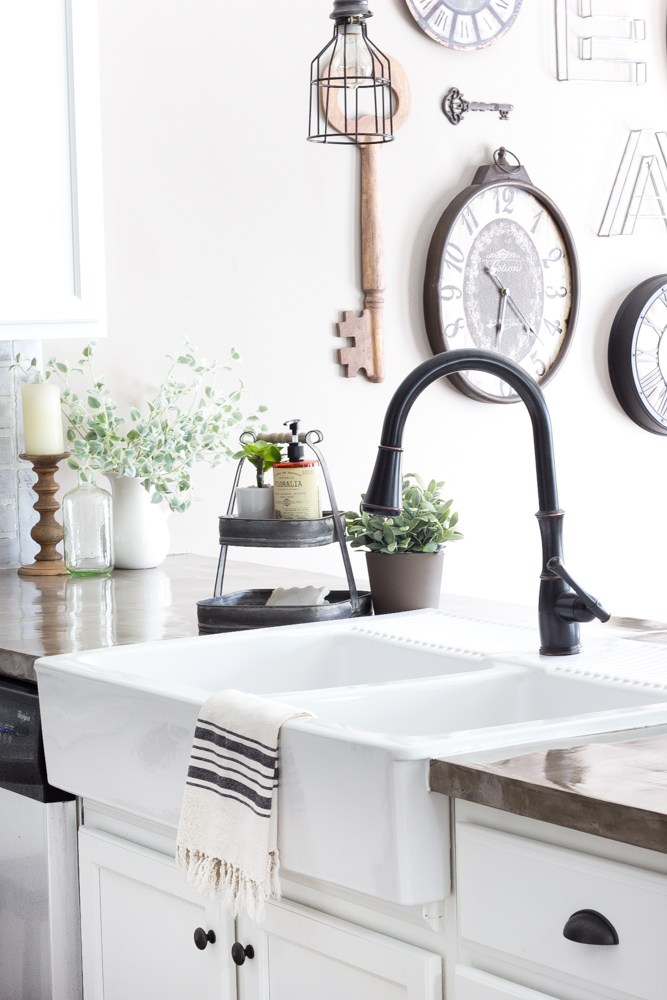 white farmhouse sink with towel draped over the front edge