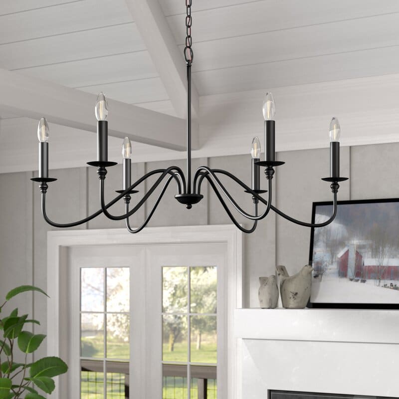 traditional candle style chandelier hanging from a ceiling