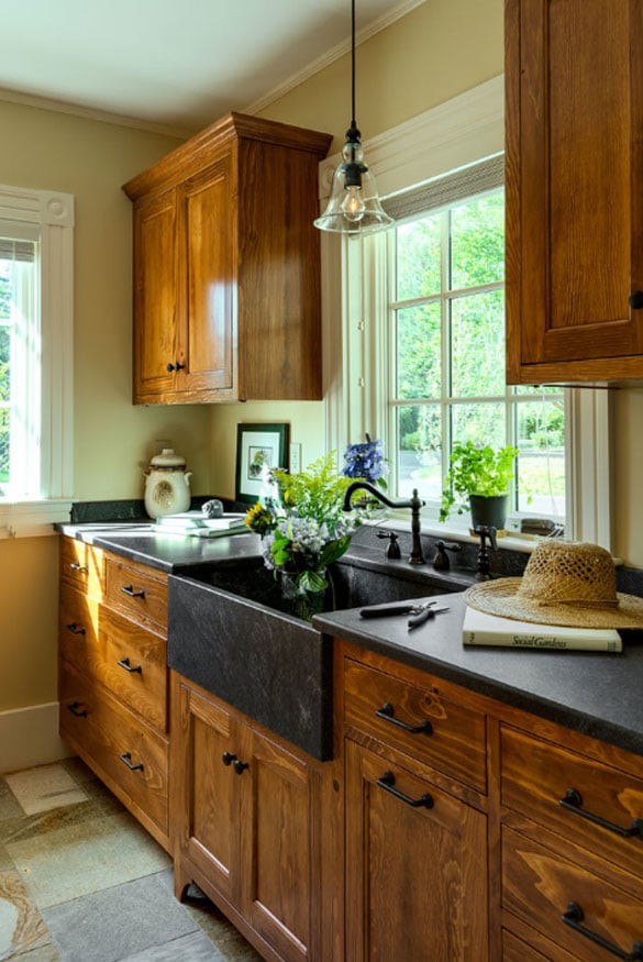 kitchen with wood cabinets and a black stone apron sink