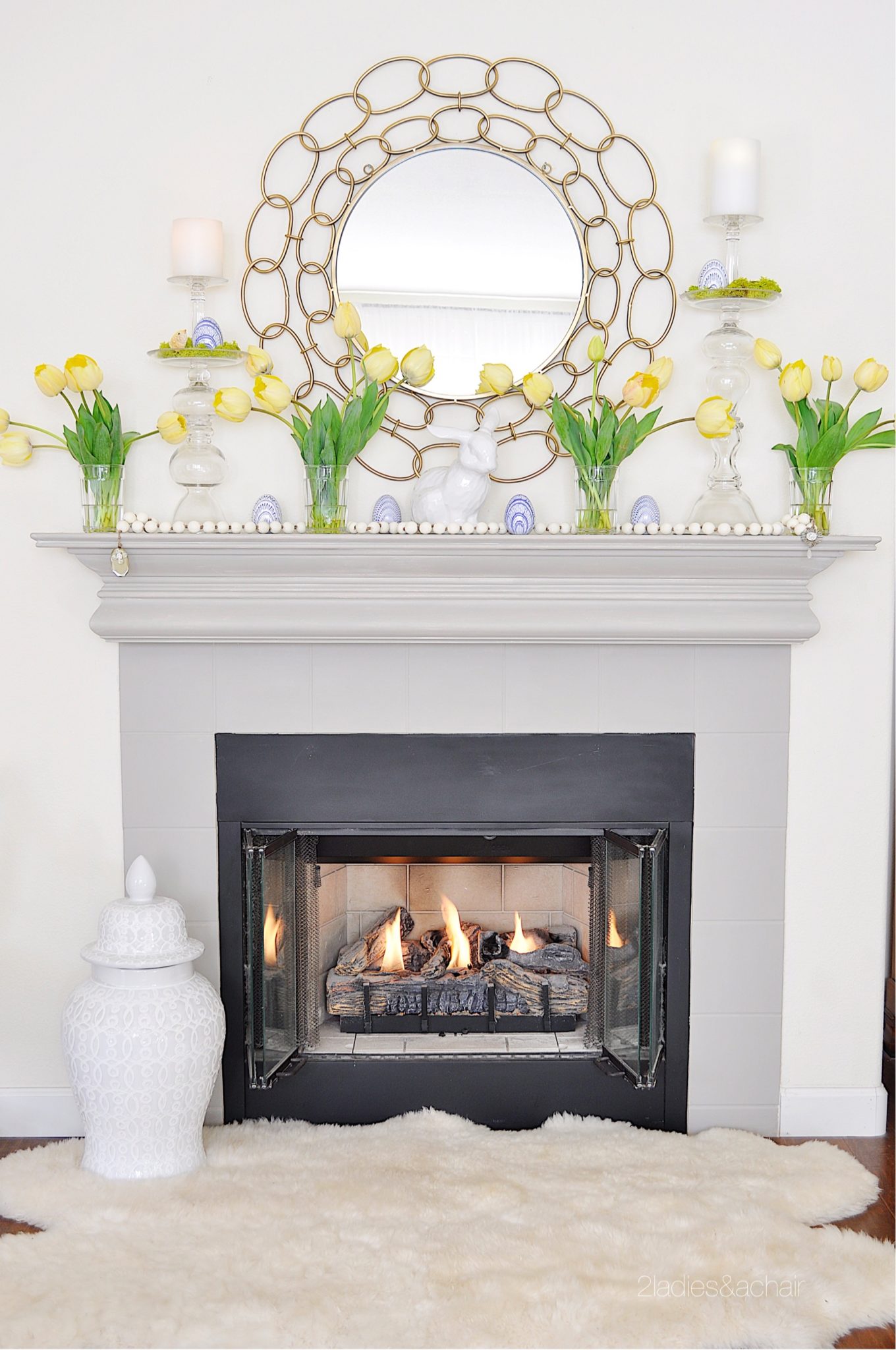 lovely springtime mantel decorations with yellow tulips and a circle mirror