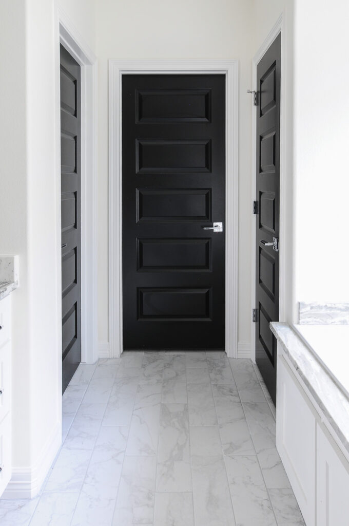 hallway with white walls and black interior door paint color