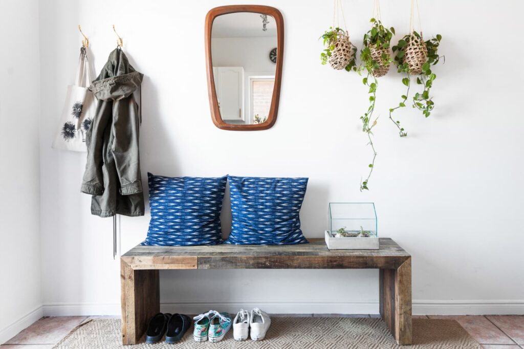 Beautifully styled entryway with bench and hooks for hanging jackets and bags.