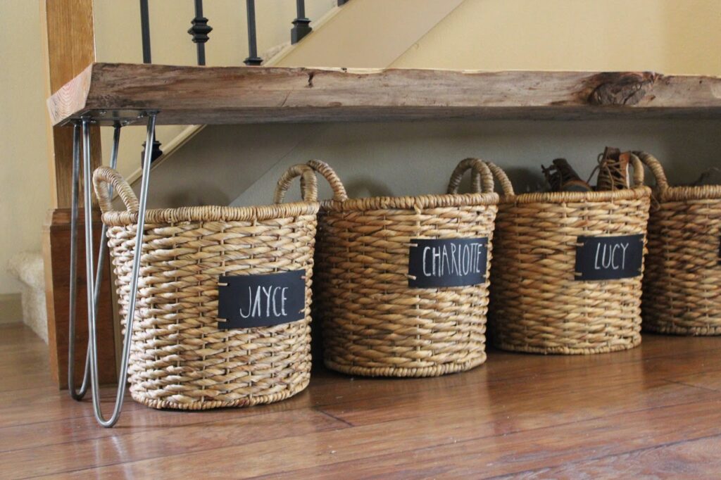 Small entryway storage ideas: labeled baskets tucked away underneath a bench keeps personal belongings organized and out of sight.