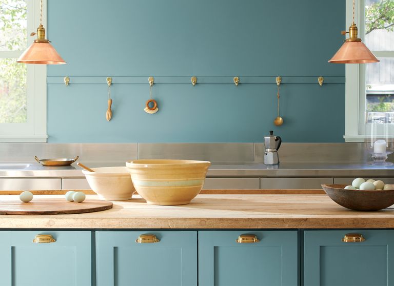 Benjamin Moore’s Color of the Year for 2021, Aegean Teal painted on a kitchen wall and cabinets.