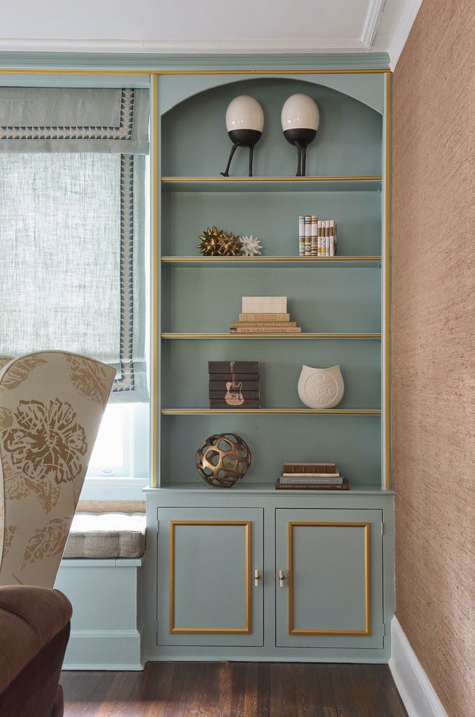 Benjamin Moore Rhine River painted on a built-in bookcase with gold trim.