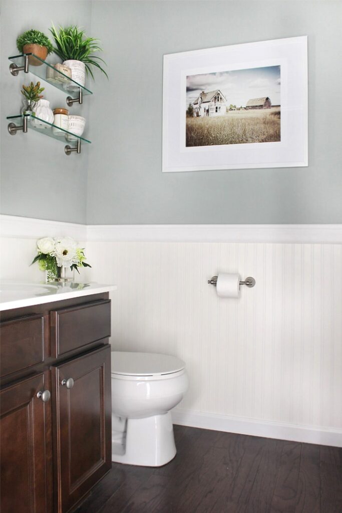 Sherwin Williams Oyster Bay is a pretty light-to-medium green paint shade. It looks great in this powder room, paired with white bead board.