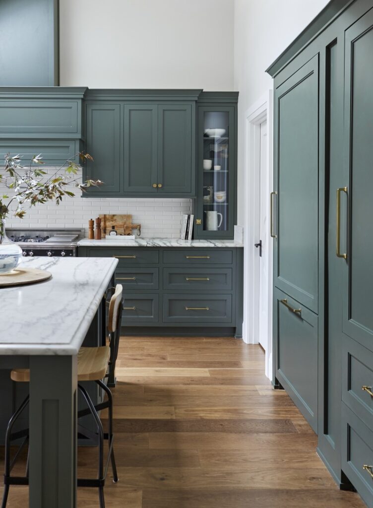 Kitchen cabinets in Pewter Green by Sherwin Williams, paired with gold cabinet hardware.