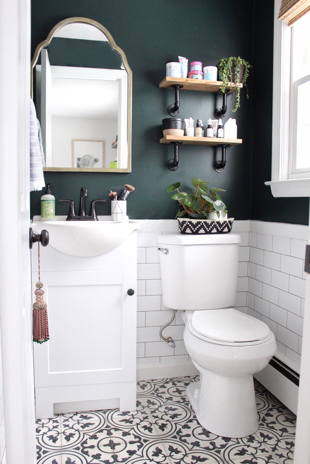 Powder room with white subway tile and upper walls painted Salamander by Benjamin Moore.