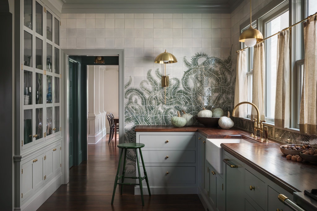 Storm Cloud Gray is a beautiful medium green paint shade that looks stunning on the cabinetry and trim in this moody kitchen. 