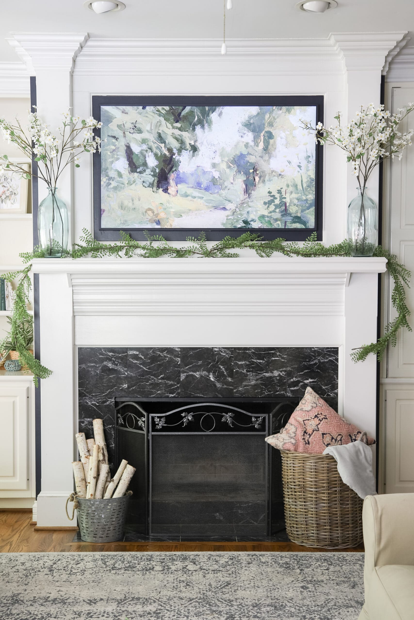 mounted Frame TV above fireplace mantle in living room
