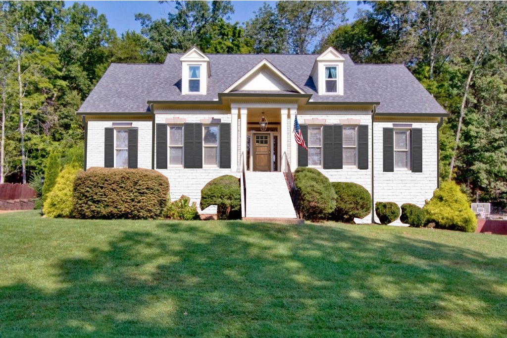 White brick cape cod style home