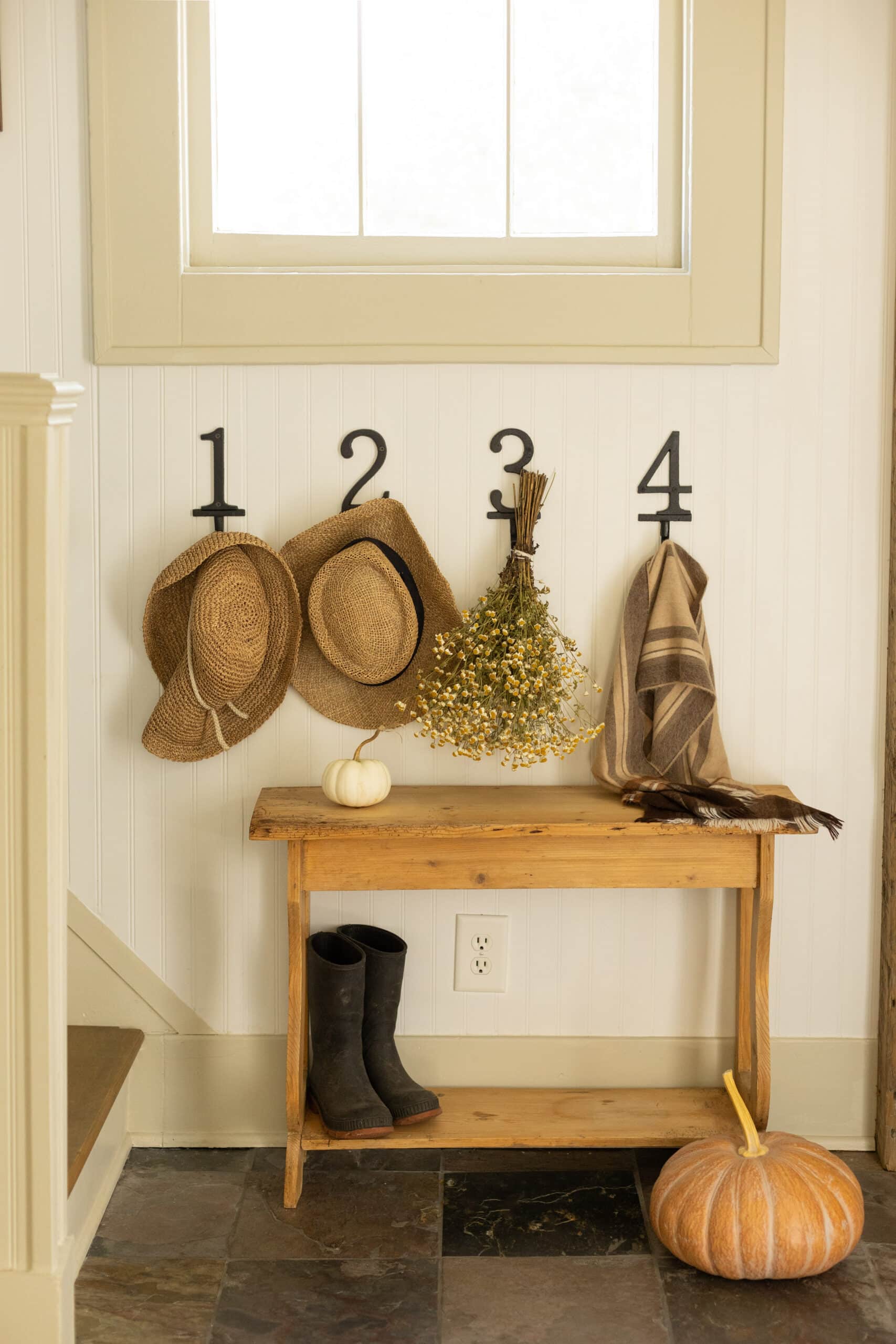 numbered hooks in entryway from pine and prospect home