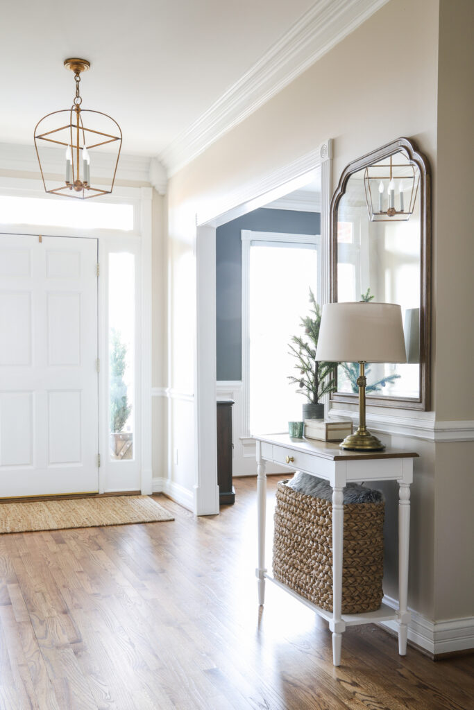 An Organized Foyer with table, lamp and mirror!