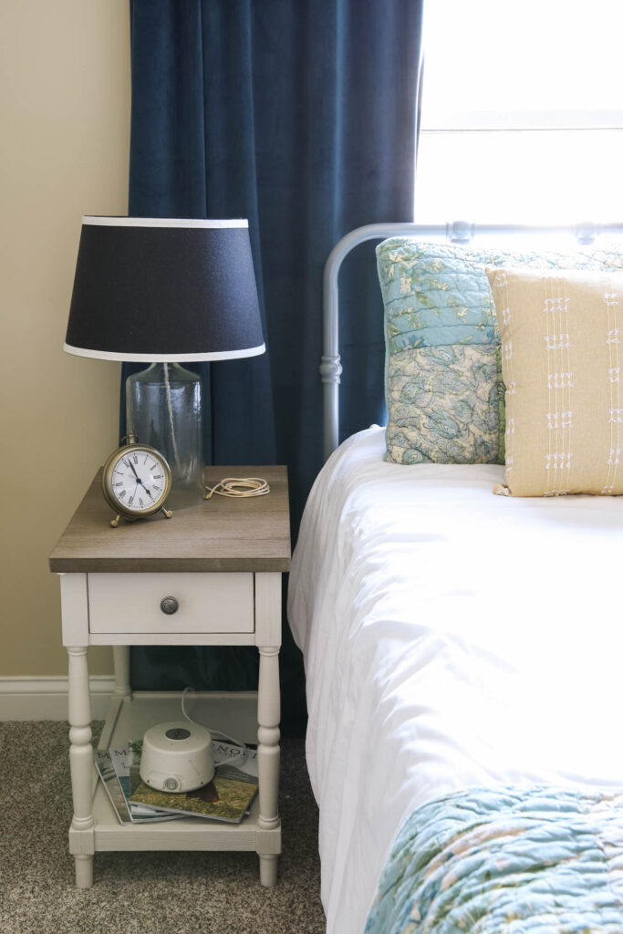 clock, noise machine and lamp in guest bedroom