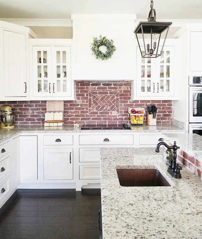 Alabaster cabinets with brick backsplash