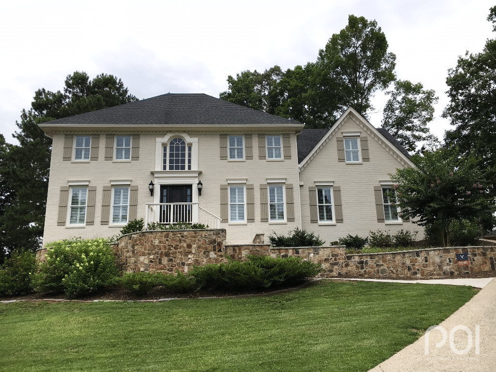 large two story home with sw accessible beige painted brick