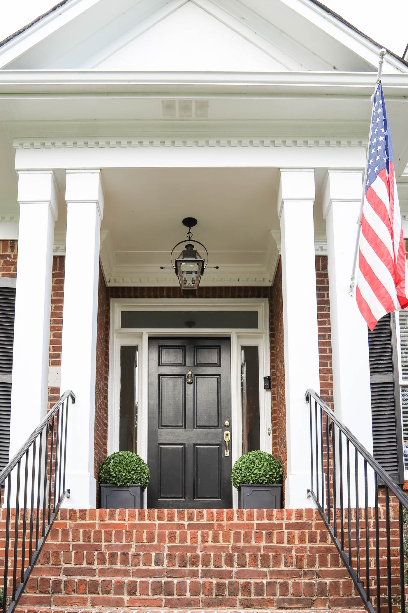 Brick Cape Cod Porch with Black Door