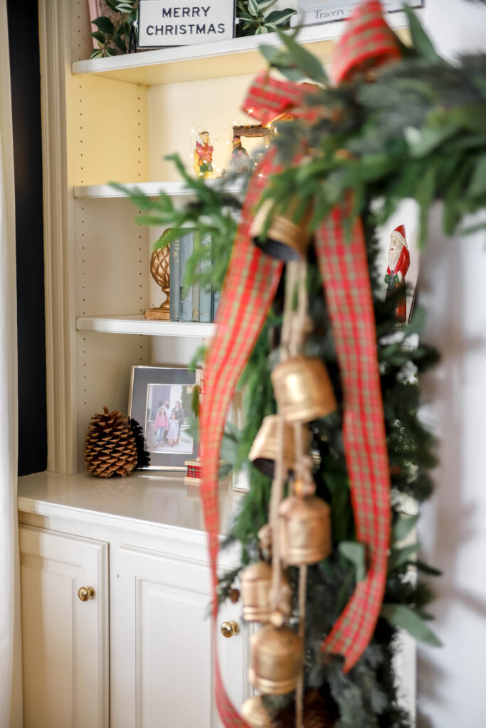 Peek-a-boo Santa on bookshelves