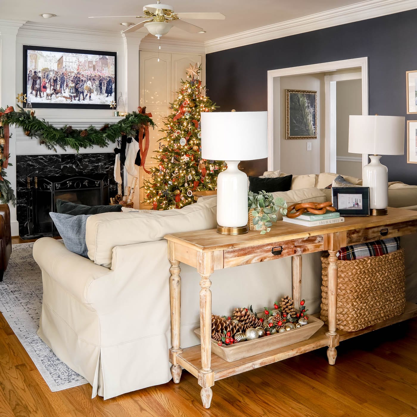 Holiday decor in living room with basket of ornaments and pinecones