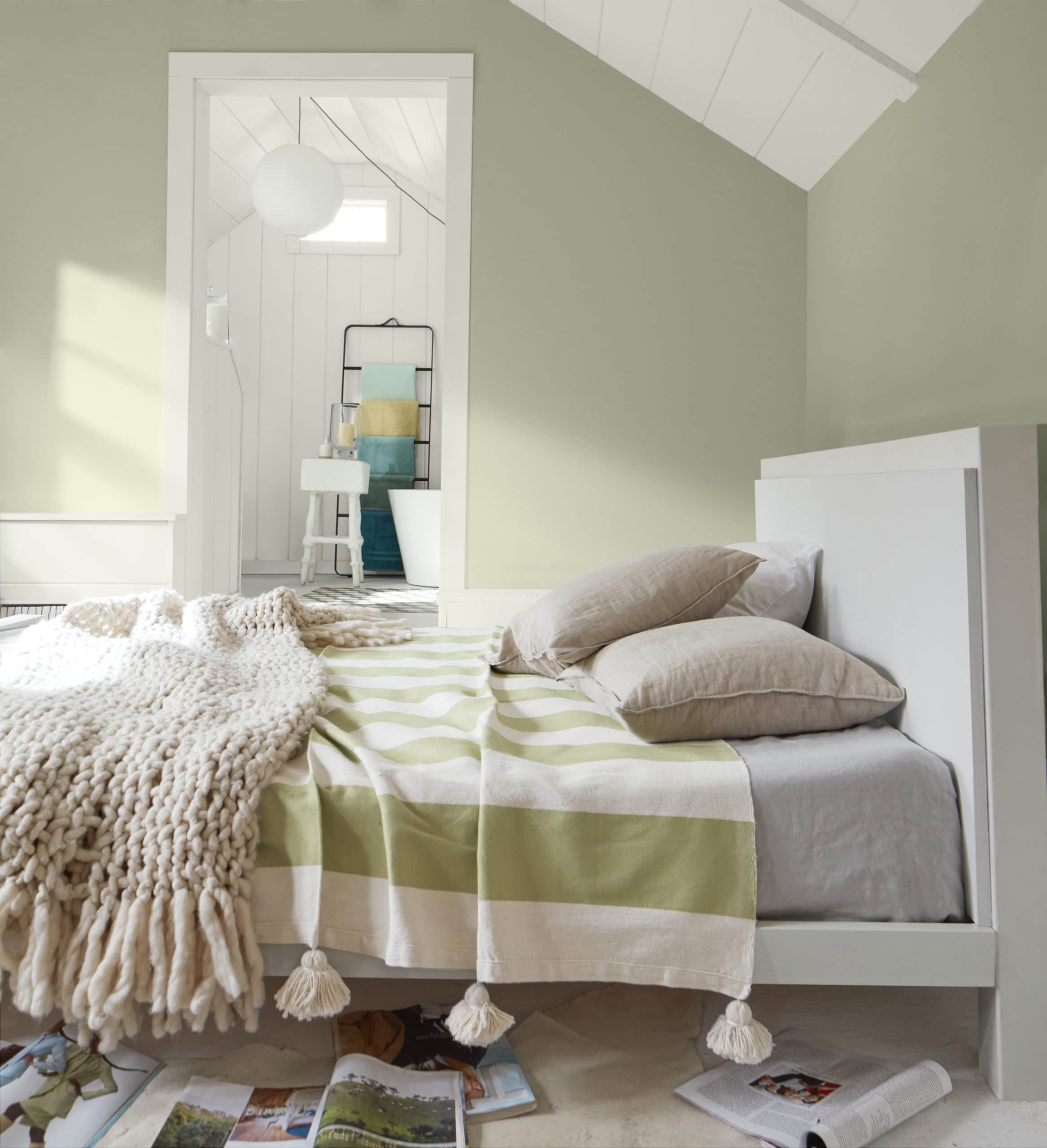Benjamin Moore October Mist walls with white bed and green and white striped bedding.
