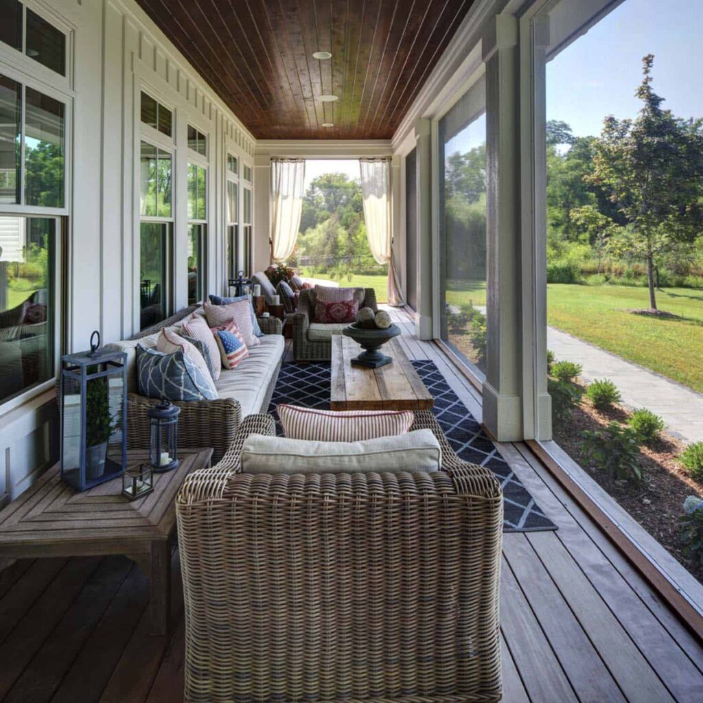 screened-in porch decorated with tables and chairs