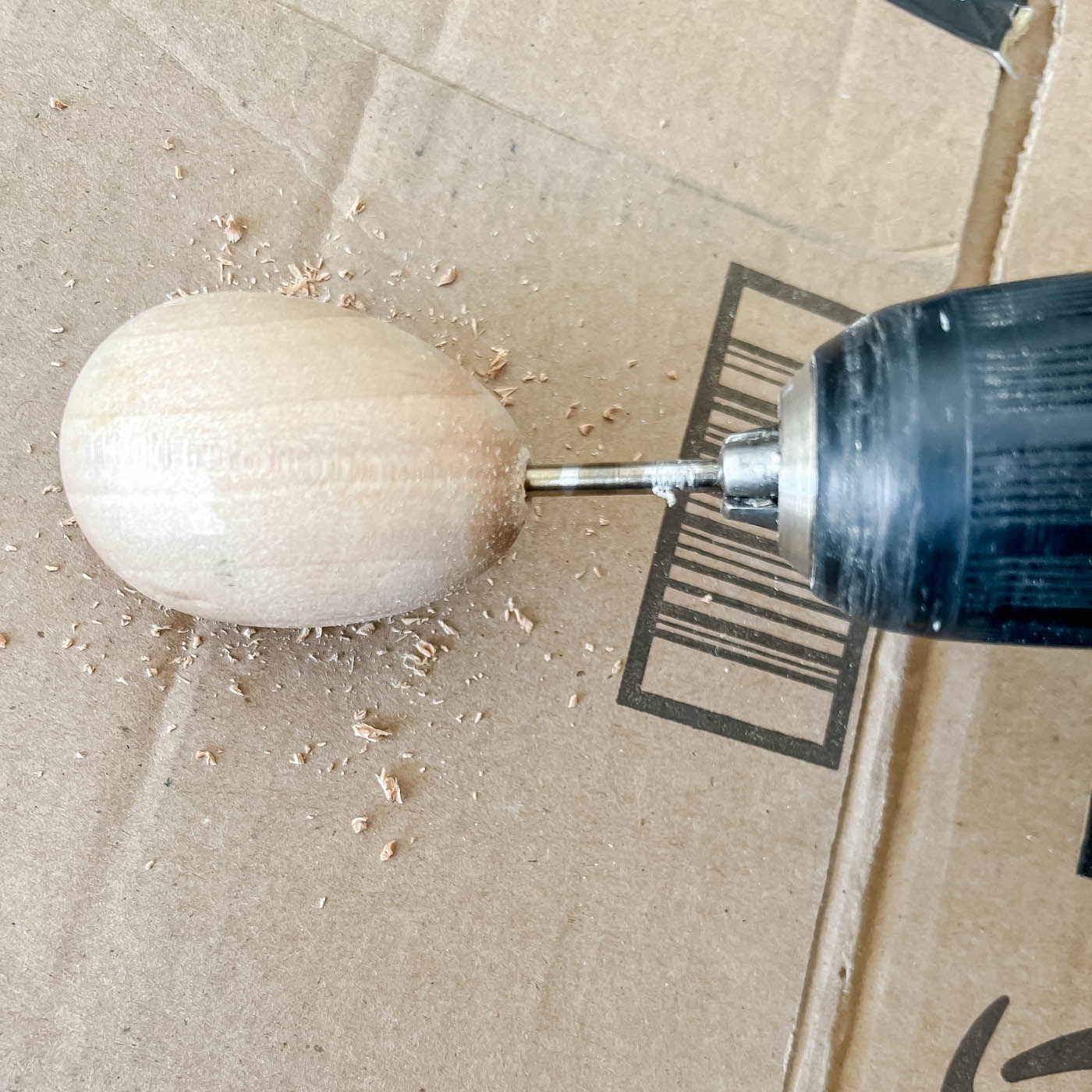 Drilling a hole in a wooden egg