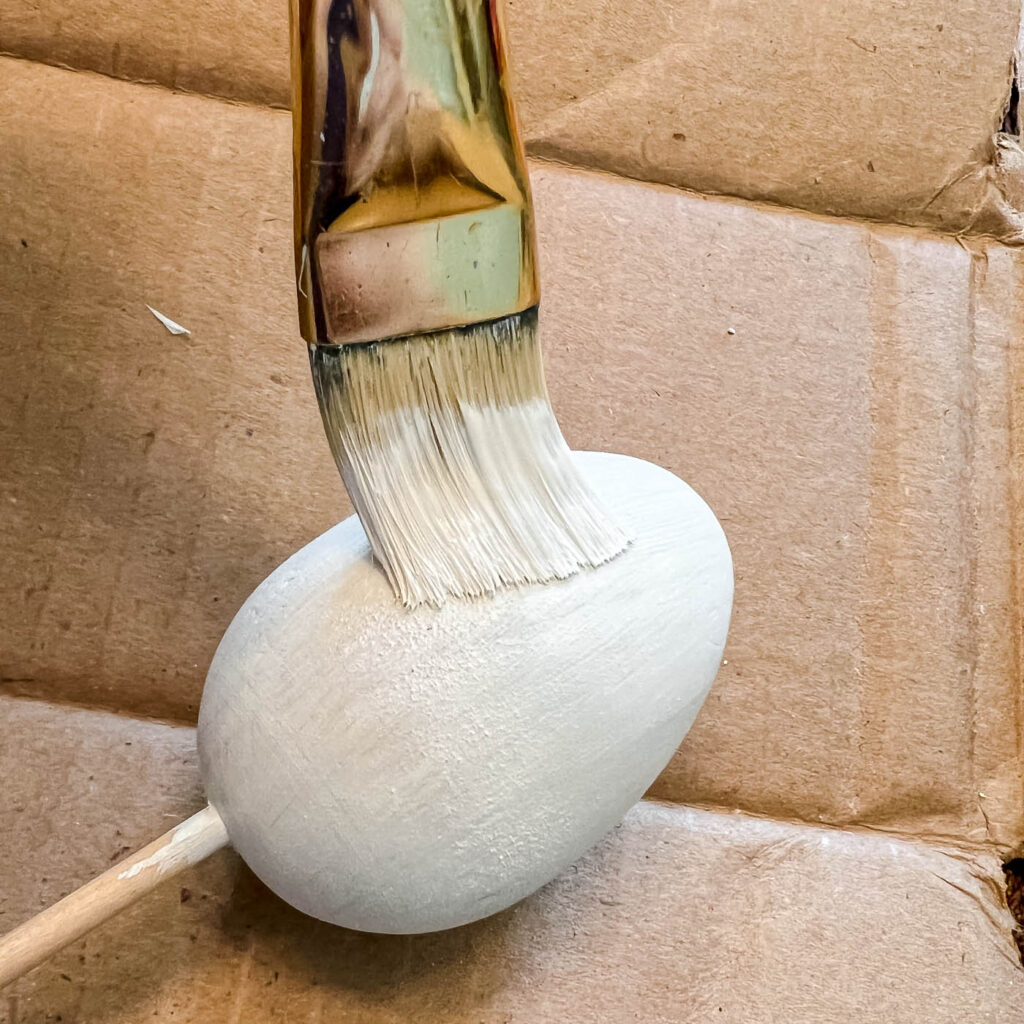 painting a wooden egg white
