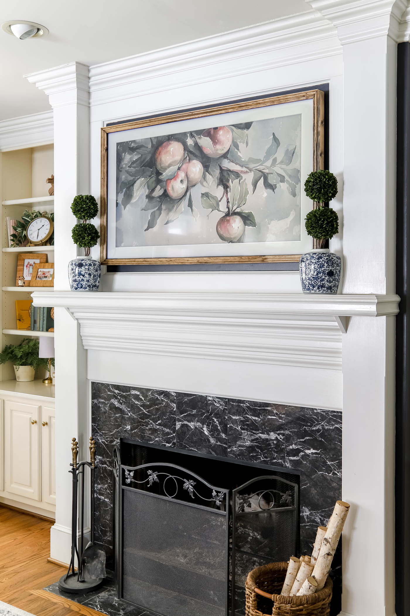 Framed TV over a fireplace mantel in living room