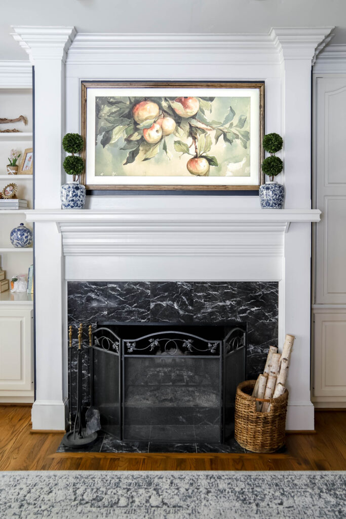 Frame TV above fireplace mantel