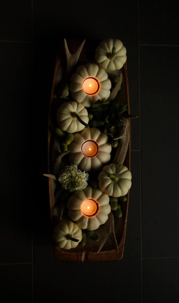 fall arrangement with pumpkins and tea lights