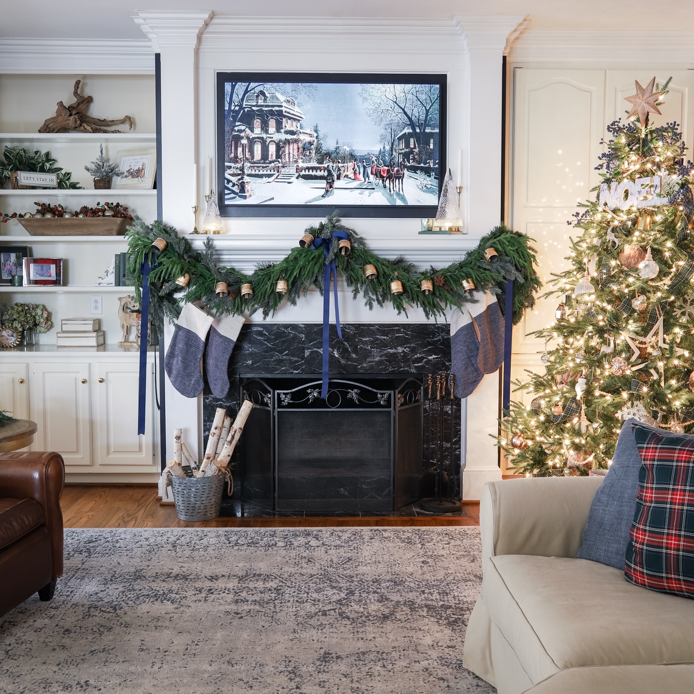 add seasonal decor to a mantel with a TV above it.