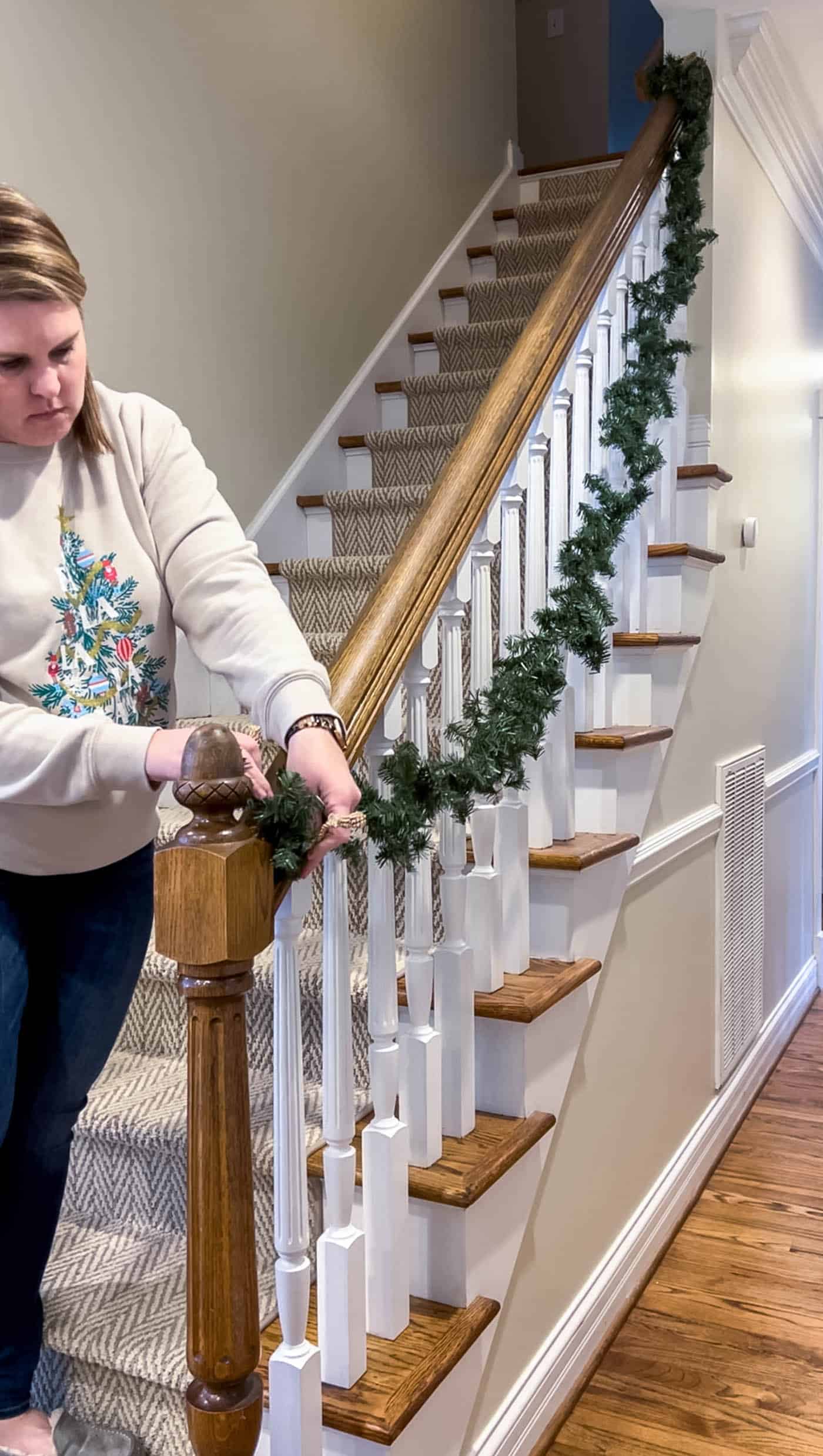 Hang the first garland on the stairs