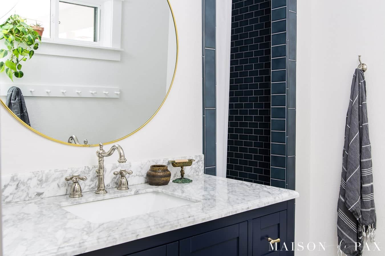 bathroom with white walls and navy accents