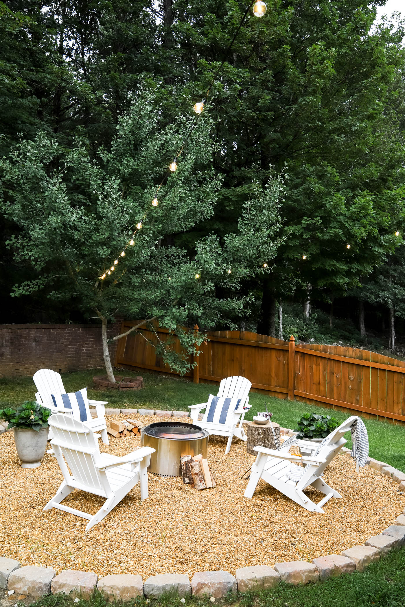white Adirondack chairs and outdoor fire pit area with solo stove