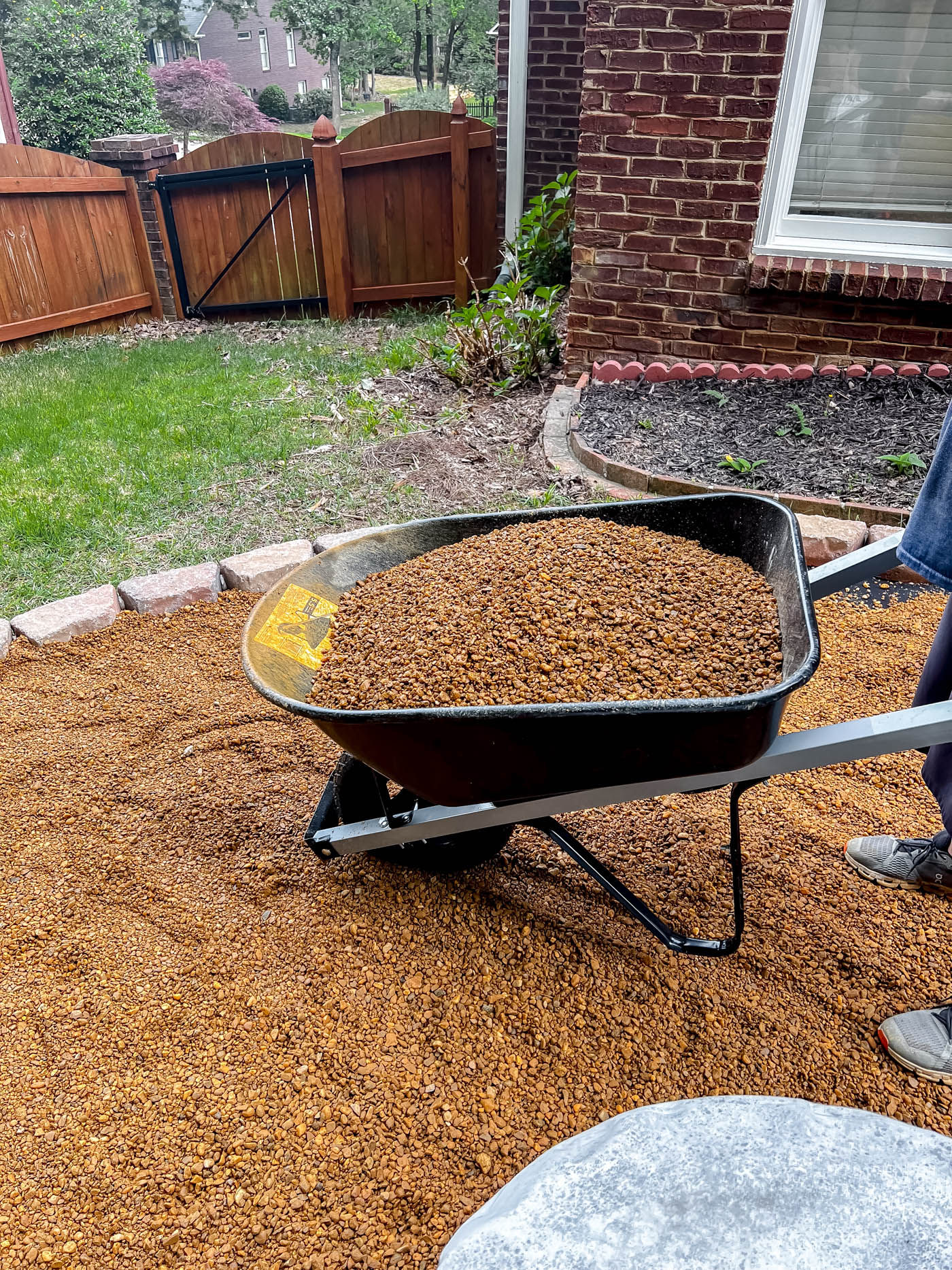 Add pea gravel to fire pit area. 