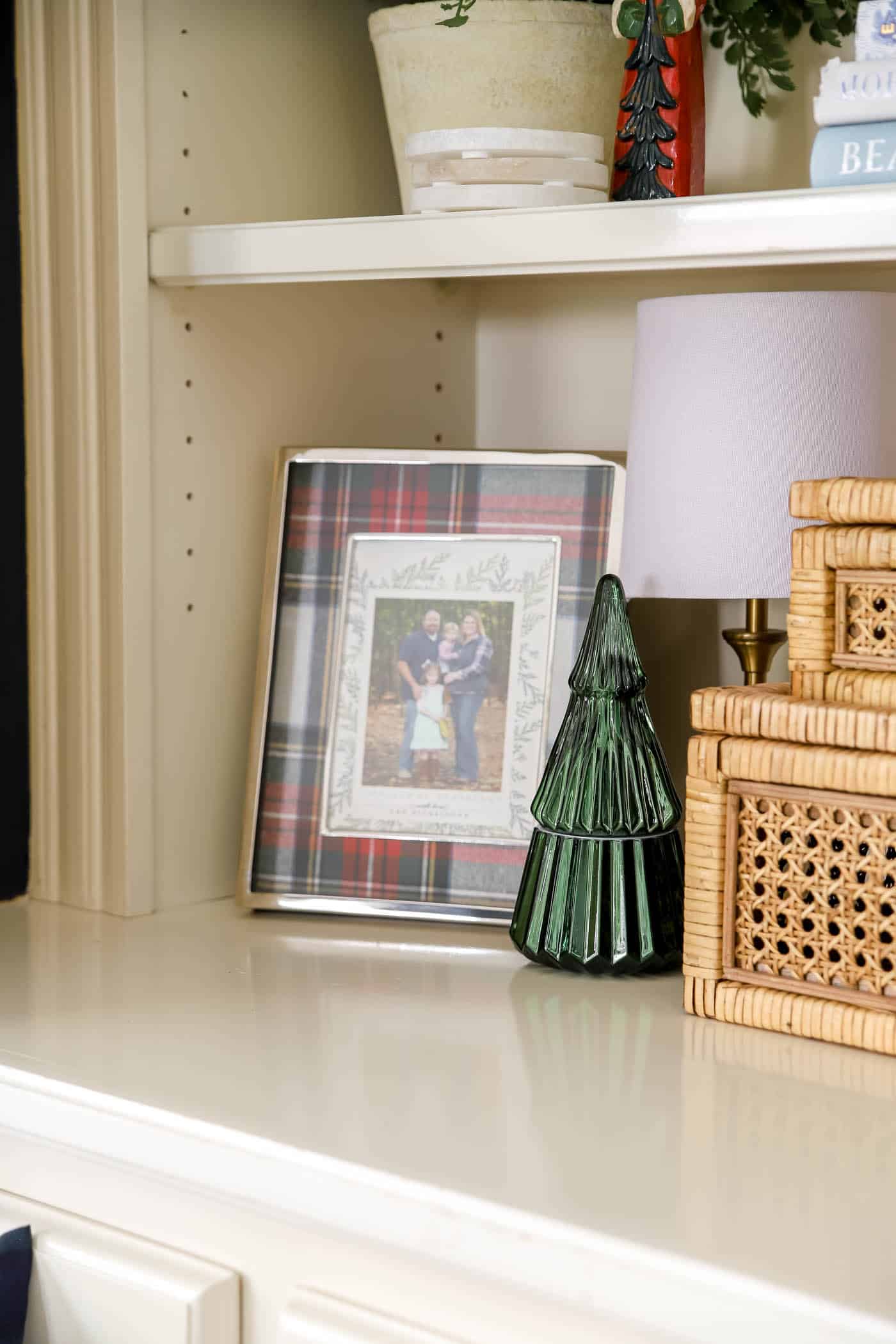 green candle decor and plaid picture frame