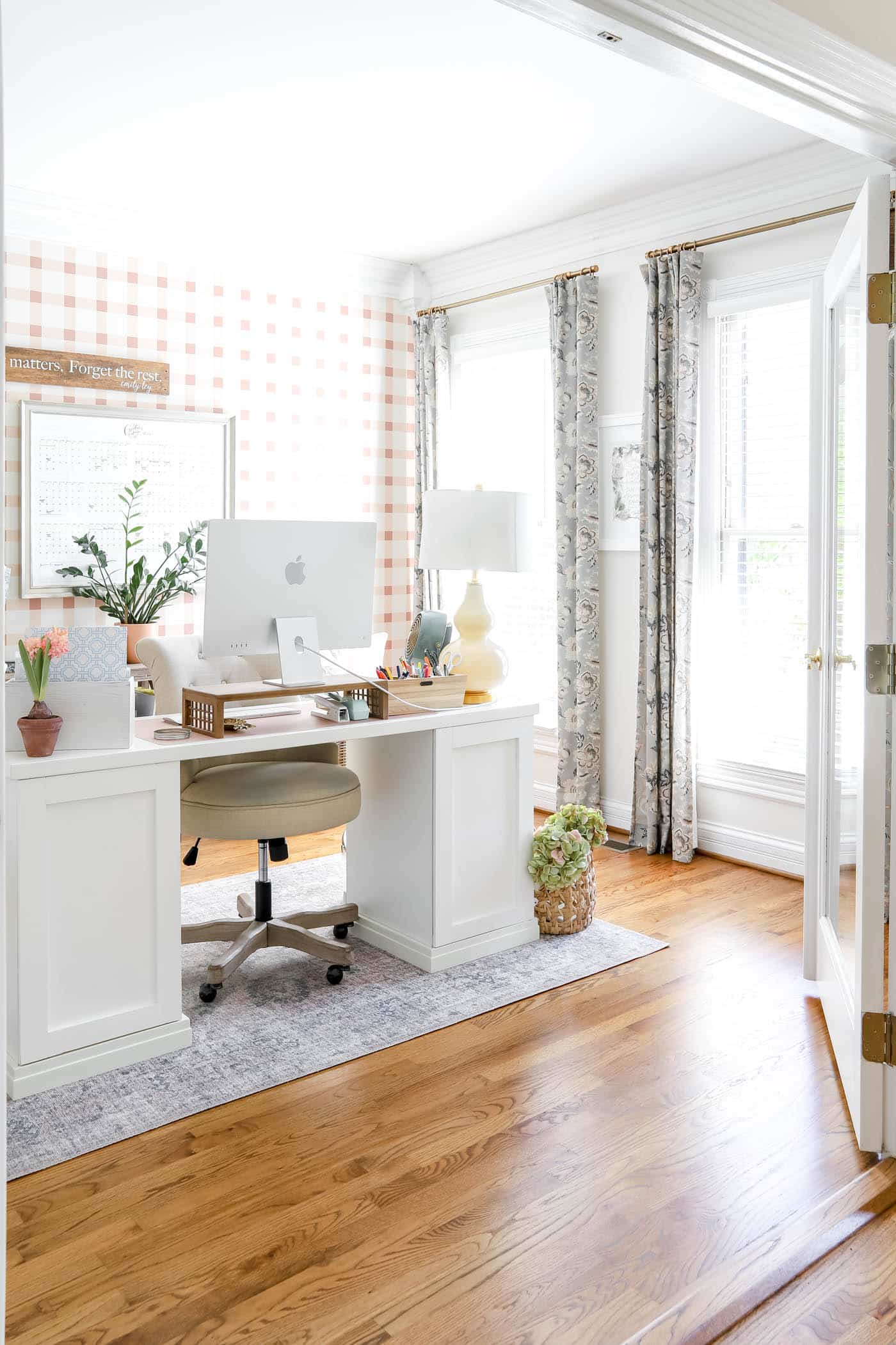 Office with plaid pink and off-white walls
