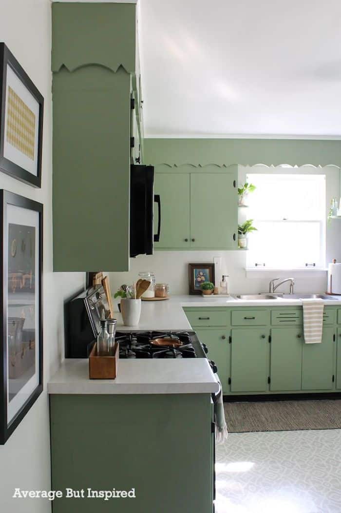 kitchen with white countertops and Behr Hillside Green painted cabinets