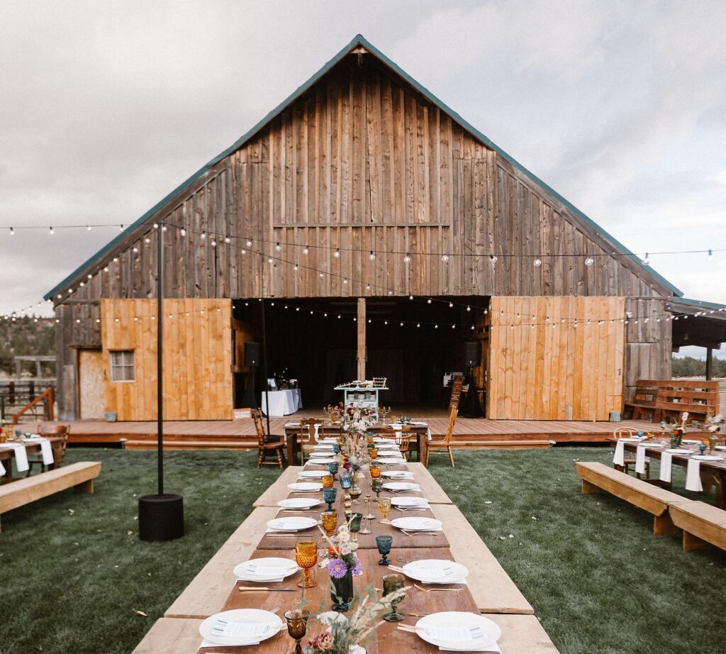 barn with party tables and string lights.